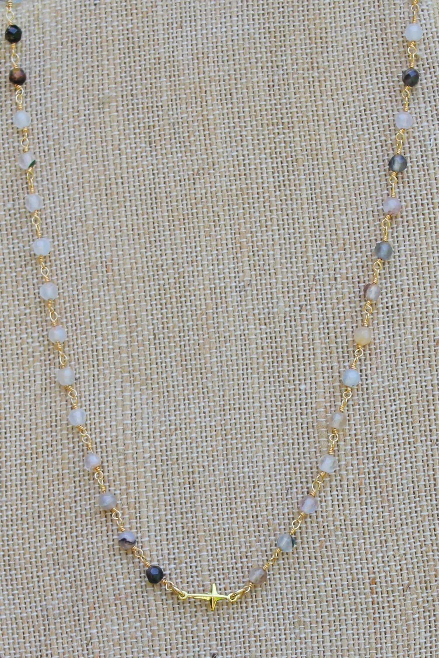 N112G; Tiny Goldtone Cross; 3mm Black Agate Goldtone Chain; Approximately 16 inches; ; ; ; Majestees