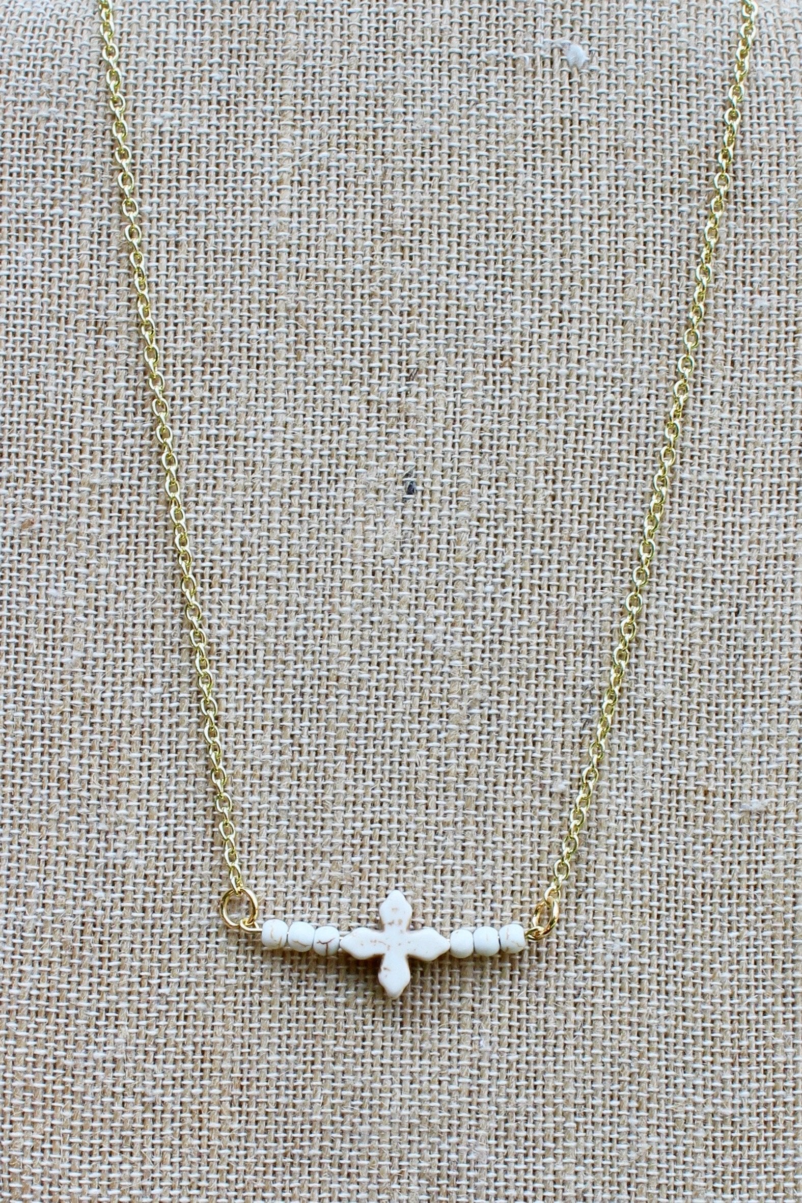 N150GW; White Stone Cross; Beads; Goldtone Chain; Approximately 16 inches; ; ; Majestees